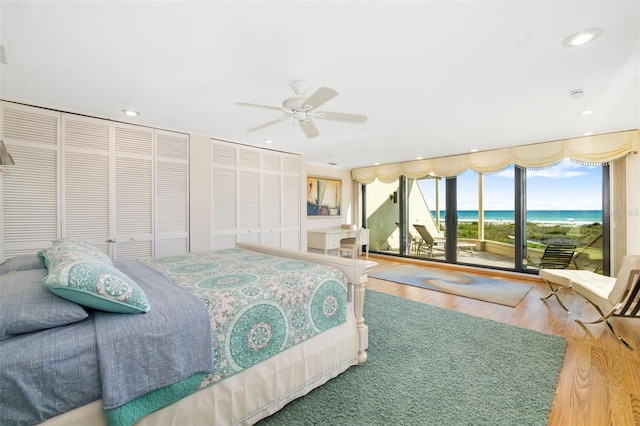 546A Beach Rd Unit A544, Sarasota, FL 34242 - bedroom featuring access to outside, wood finished floors, recessed lighting, a water view, and a ceiling fan