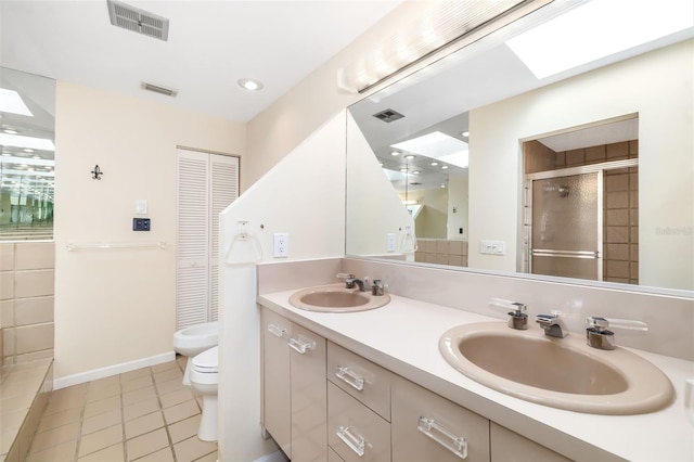 546A Beach Rd Unit A544, Sarasota, FL 34242 - bathroom with tile patterned floors, double vanity, a stall shower, a bidet, and a closet