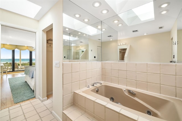 546A Beach Rd Unit A544, Sarasota, FL 34242 - bathroom with a skylight, ensuite bathroom, a whirlpool tub, recessed lighting, and tile patterned flooring