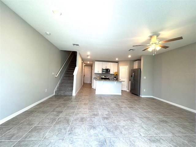 5812 Ocean Isle Dr, Nokomis, FL 34275 - unfurnished living room with ceiling fan, stairway, light tile patterned flooring, and recessed lighting