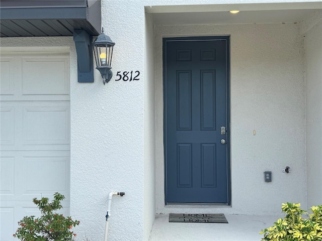 5812 Ocean Isle Dr, Nokomis, FL 34275 - doorway to property with stucco siding
