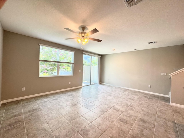 5812 Ocean Isle Dr, Nokomis, FL 34275 - tiled spare room with a ceiling fan and a textured ceiling