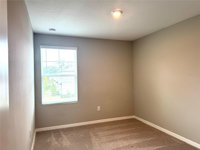 5812 Ocean Isle Dr, Nokomis, FL 34275 - carpeted empty room featuring a textured ceiling and a smoke detector