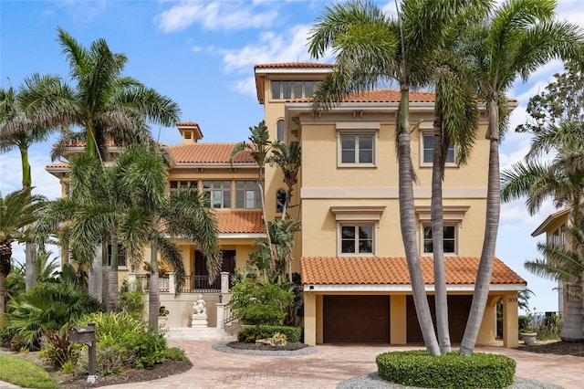 309 Ringling Point Dr, Sarasota, FL 34234 - view of front facade featuring a tile roof, decorative driveway, and an attached garage