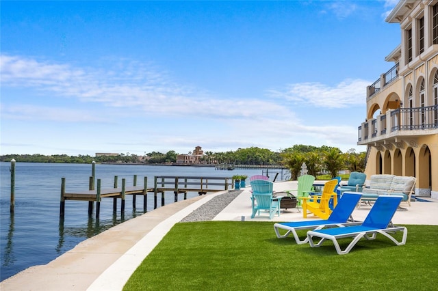 309 Ringling Point Dr, Sarasota, FL 34234 - dock featuring a lawn and a water view