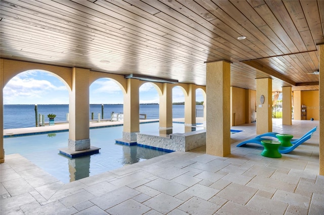 309 Ringling Point Dr, Sarasota, FL 34234 - indoor pool featuring a patio area and a water view