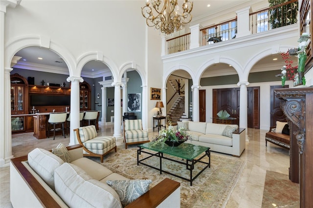 309 Ringling Point Dr, Sarasota, FL 34234 - living room with decorative columns, a high ceiling, crown molding, a chandelier, and recessed lighting
