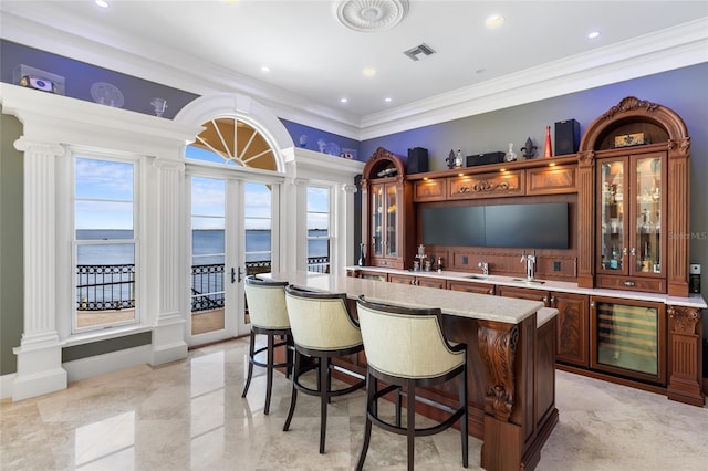 309 Ringling Point Dr, Sarasota, FL 34234 - indoor wet bar with beverage cooler, decorative columns, ornamental molding, and recessed lighting