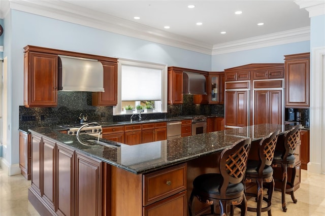 309 Ringling Point Dr, Sarasota, FL 34234 - kitchen featuring wall chimney exhaust hood, appliances with stainless steel finishes, a kitchen breakfast bar, dark stone countertops, and recessed lighting