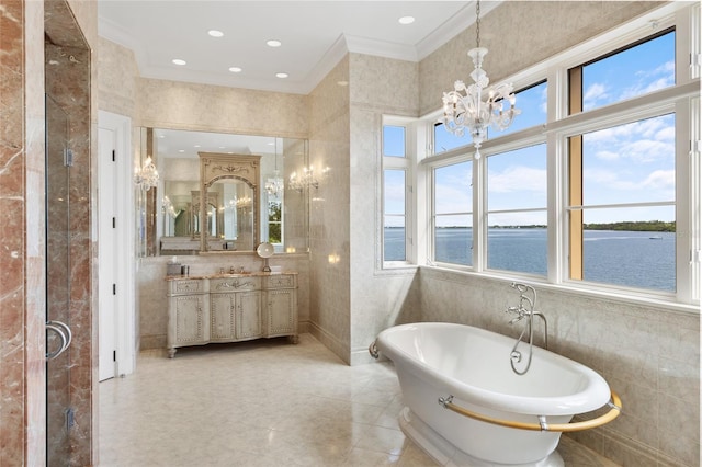 309 Ringling Point Dr, Sarasota, FL 34234 - bathroom featuring tile walls, a chandelier, vanity, a freestanding bath, and a water view
