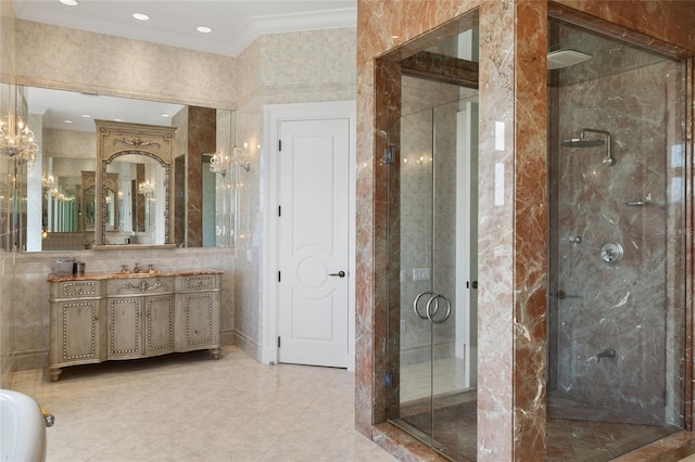 309 Ringling Point Dr, Sarasota, FL 34234 - bathroom featuring a shower stall, vanity, crown molding, tile walls, and recessed lighting