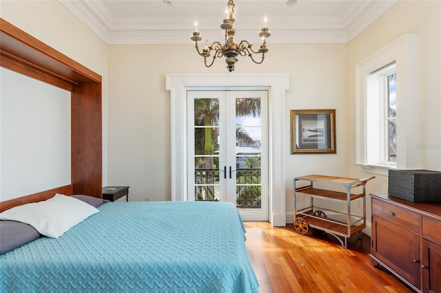 309 Ringling Point Dr, Sarasota, FL 34234 - bedroom with french doors, a chandelier, light wood-style floors, access to outside, and ornamental molding