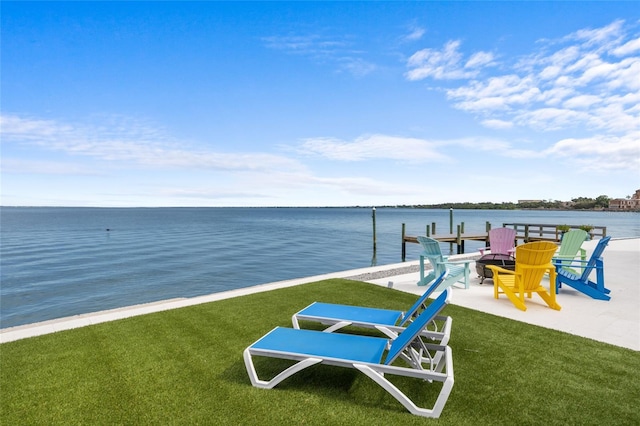 309 Ringling Point Dr, Sarasota, FL 34234 - dock area featuring a water view, a lawn, a fire pit, and a patio