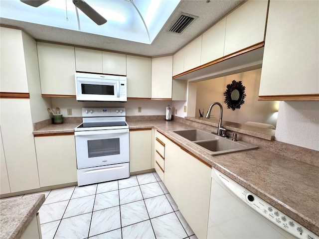 6505 Stone River Rd Unit 309, Bradenton, FL 34203 - kitchen with white appliances and ceiling fan