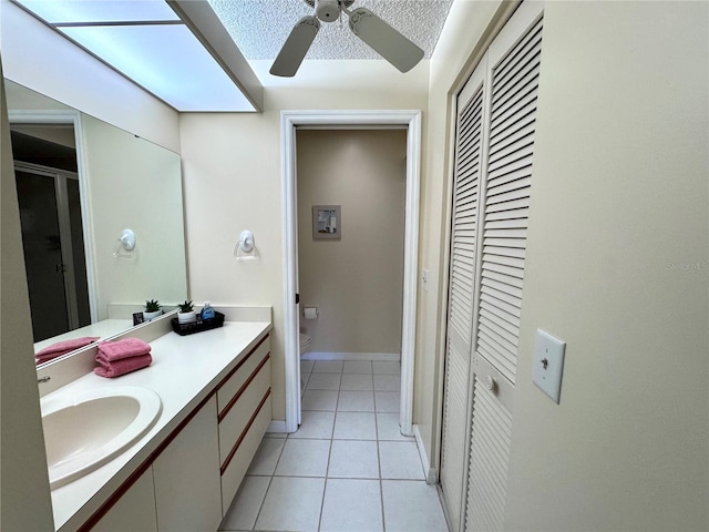 6505 Stone River Rd Unit 309, Bradenton, FL 34203 - bathroom with a closet, vanity, tile patterned flooring, a ceiling fan, and a shower stall
