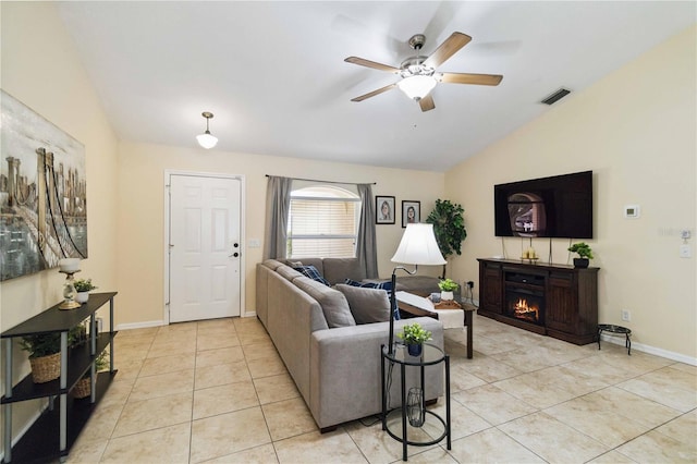 4649 72nd Ct E, Bradenton, FL 34203 - living area featuring vaulted ceiling, a warm lit fireplace, ceiling fan, and light tile patterned flooring