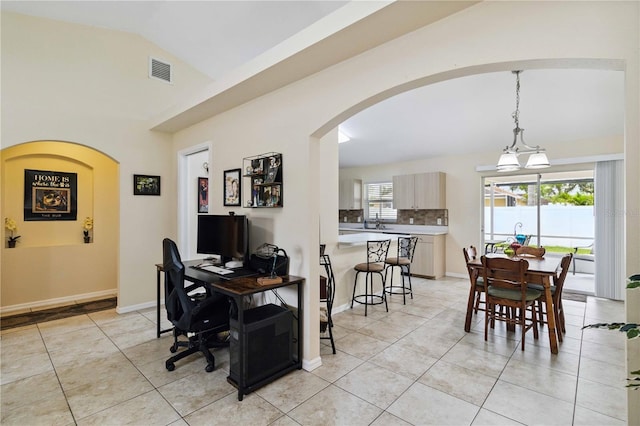 4649 72nd Ct E, Bradenton, FL 34203 - dining room featuring light tile patterned floors, arched walkways, vaulted ceiling, and an office area
