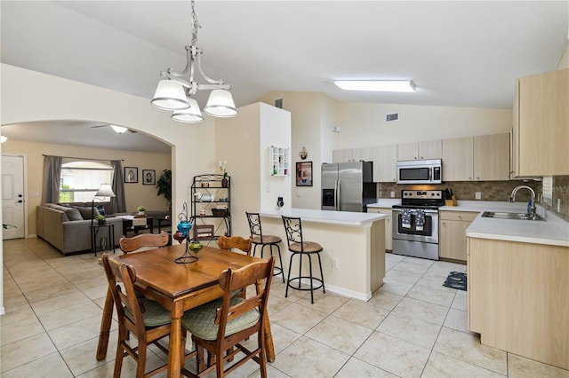 4649 72nd Ct E, Bradenton, FL 34203 - dining space featuring lofted ceiling, light tile patterned floors, arched walkways, and a chandelier