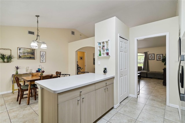 4649 72nd Ct E, Bradenton, FL 34203 - kitchen featuring a peninsula, arched walkways, light countertops, lofted ceiling, and light tile patterned flooring