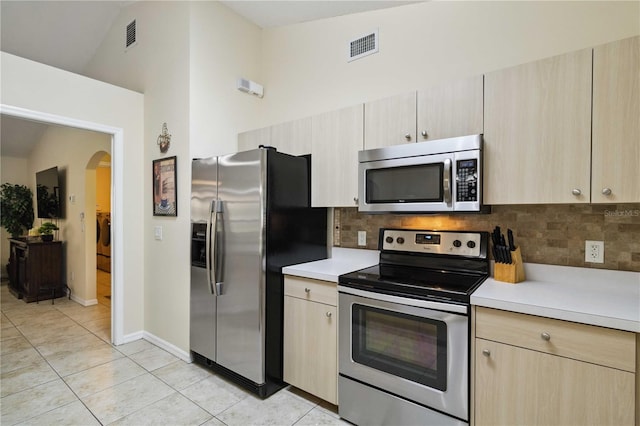 4649 72nd Ct E, Bradenton, FL 34203 - kitchen with appliances with stainless steel finishes, arched walkways, light countertops, and decorative backsplash
