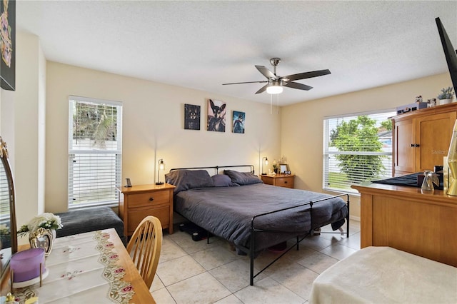 4649 72nd Ct E, Bradenton, FL 34203 - bedroom with light tile patterned floors, ceiling fan, and a textured ceiling