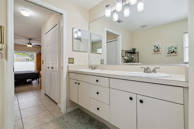 4649 72nd Ct E, Bradenton, FL 34203 - full bathroom with double vanity, ensuite bathroom, tile patterned floors, and ceiling fan