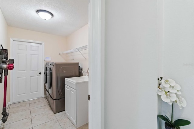 4649 72nd Ct E, Bradenton, FL 34203 - laundry area with separate washer and dryer, a textured ceiling, and light tile patterned floors