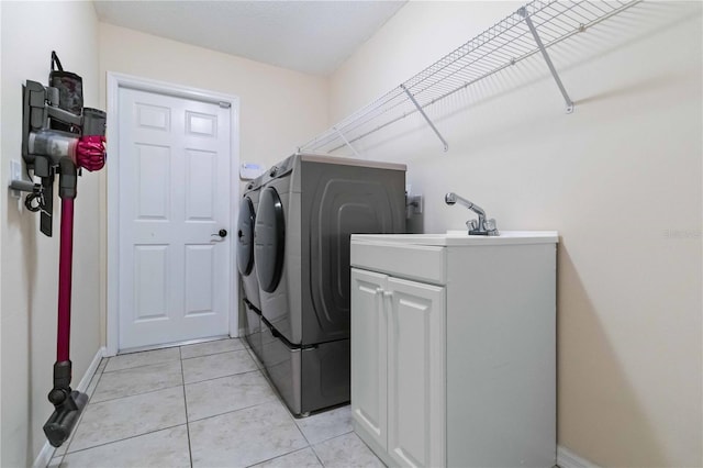 4649 72nd Ct E, Bradenton, FL 34203 - washroom featuring washer and clothes dryer, cabinet space, and light tile patterned flooring
