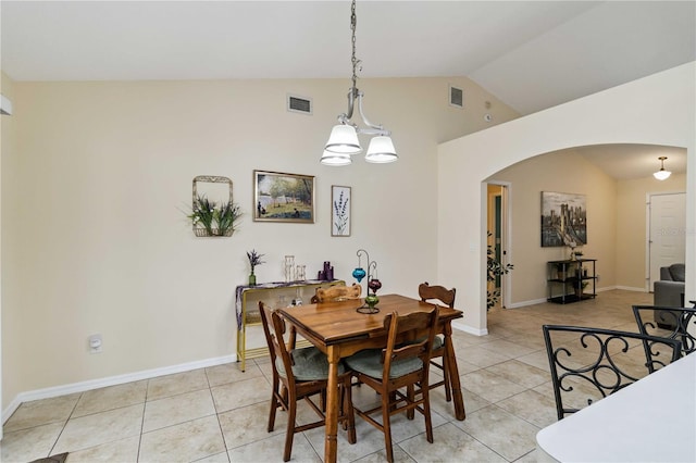 4649 72nd Ct E, Bradenton, FL 34203 - dining space featuring arched walkways, light tile patterned floors, high vaulted ceiling, and a chandelier