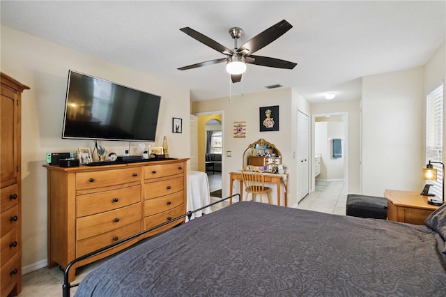 4649 72nd Ct E, Bradenton, FL 34203 - bedroom with light tile patterned flooring, arched walkways, multiple windows, and ceiling fan