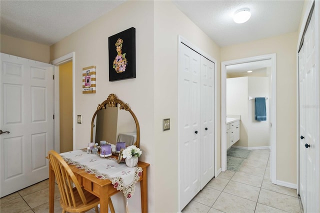 4649 72nd Ct E, Bradenton, FL 34203 - hallway with light tile patterned flooring and a textured ceiling