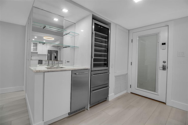 1150 Tarpon Center Dr Unit 1-C # 103, Venice, FL 34285 - bar area featuring beverage cooler and light wood finished floors