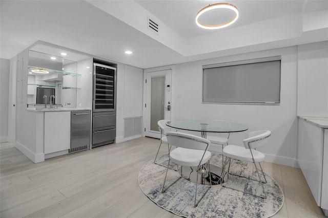 1150 Tarpon Center Dr Unit 1-C # 103, Venice, FL 34285 - dining room with light wood-type flooring, beverage cooler, recessed lighting, and bar