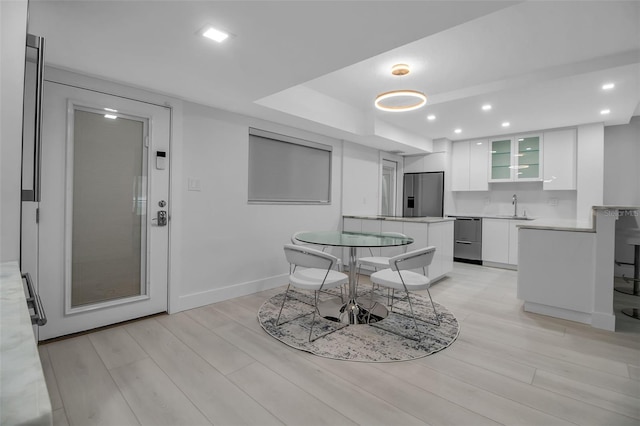 1150 Tarpon Center Dr Unit 1-C # 103, Venice, FL 34285 - dining area featuring light wood finished floors, recessed lighting, and bar