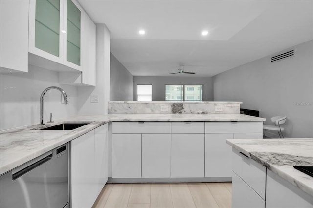 1150 Tarpon Center Dr Unit 1-C # 103, Venice, FL 34285 - kitchen with stainless steel dishwasher, white cabinets, light stone countertops, ceiling fan, and recessed lighting