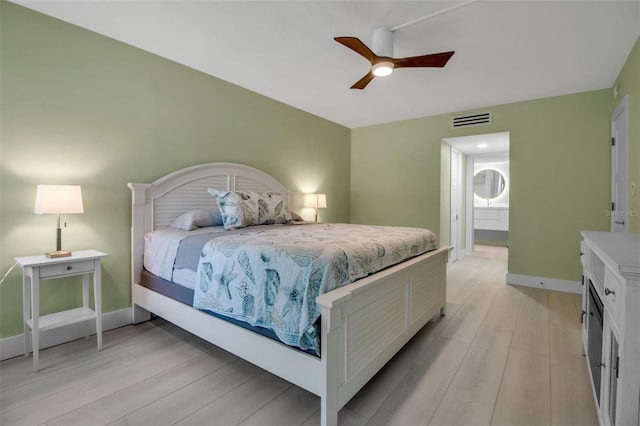 1150 Tarpon Center Dr Unit 1-C # 103, Venice, FL 34285 - bedroom featuring light wood-style floors, a ceiling fan, and ensuite bath