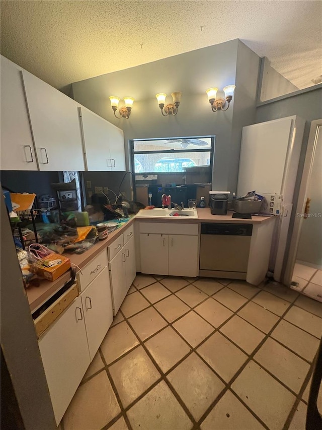 303 70th St NW, Bradenton, FL 34209 - kitchen with dishwasher, white cabinets, a textured ceiling, light tile patterned flooring, and lofted ceiling