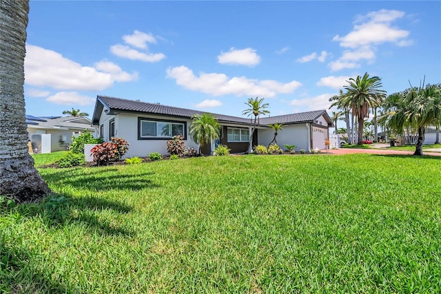 8001 13th Ave S, Saint Petersburg, FL 33707 - single story home with concrete driveway, stucco siding, a garage, a front yard, and a tiled roof