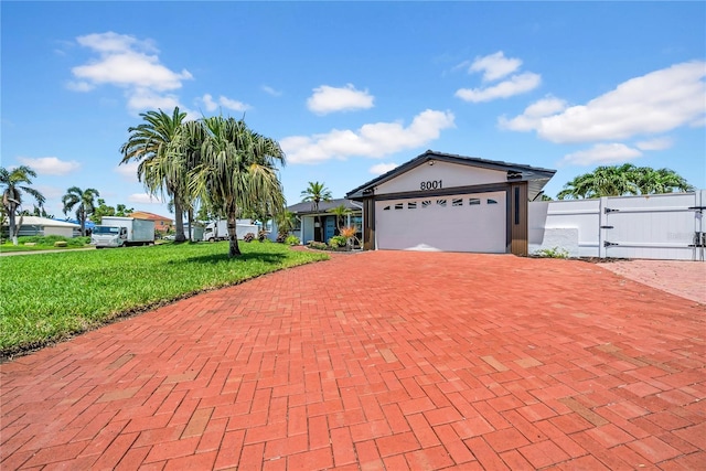 8001 13th Ave S, Saint Petersburg, FL 33707 - single story home with decorative driveway, a front yard, a gate, a garage, and stucco siding