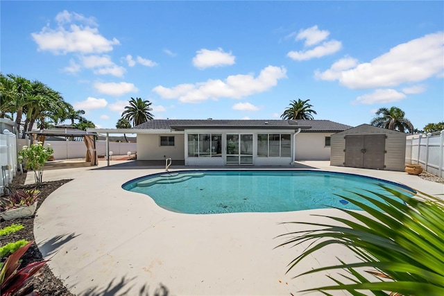 8001 13th Ave S, Saint Petersburg, FL 33707 - view of pool with a fenced backyard, a patio, a storage shed, and a sunroom
