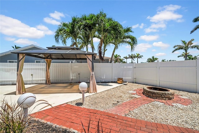 8001 13th Ave S, Saint Petersburg, FL 33707 - fenced backyard featuring an outdoor fire pit, a patio, and a gazebo