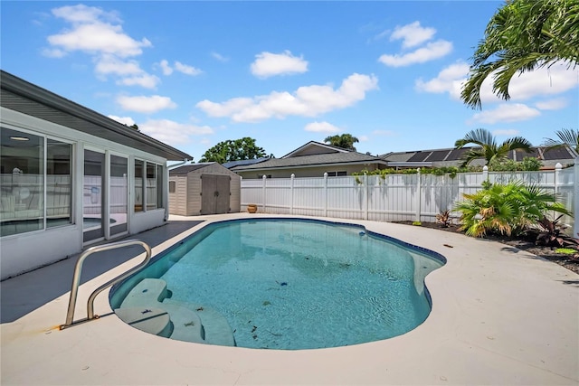 8001 13th Ave S, Saint Petersburg, FL 33707 - view of swimming pool with a shed, a fenced backyard, and a patio area