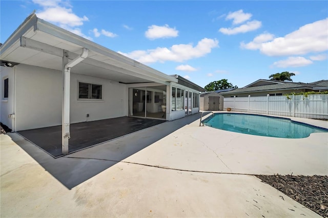 8001 13th Ave S, Saint Petersburg, FL 33707 - view of pool with a storage unit, a patio, and a fenced backyard