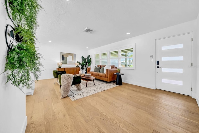 8001 13th Ave S, Saint Petersburg, FL 33707 - living area featuring light wood-style flooring and recessed lighting