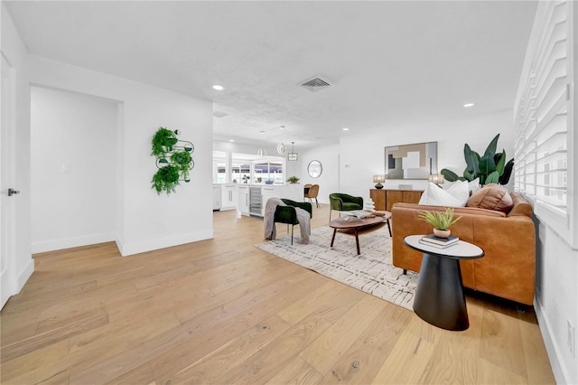 8001 13th Ave S, Saint Petersburg, FL 33707 - living area with light wood-style flooring, recessed lighting, and wine cooler