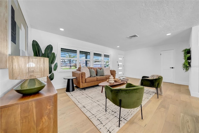 8001 13th Ave S, Saint Petersburg, FL 33707 - living room featuring wood finished floors, recessed lighting, and a textured ceiling