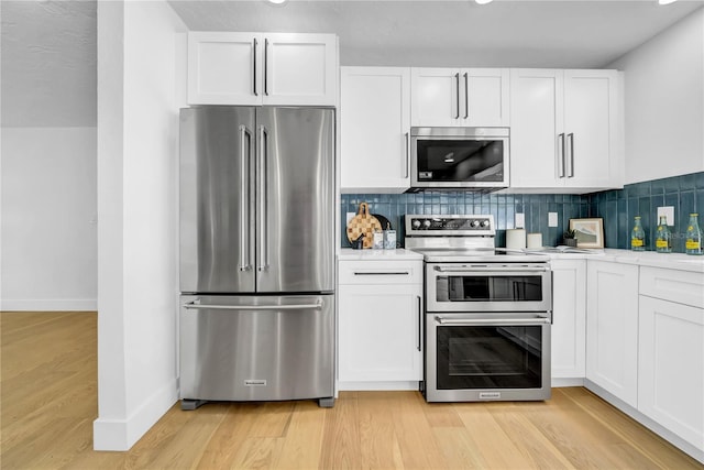 8001 13th Ave S, Saint Petersburg, FL 33707 - kitchen with stainless steel appliances, white cabinetry, and light countertops