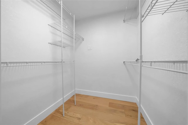 8001 13th Ave S, Saint Petersburg, FL 33707 - walk in closet featuring wood finished floors