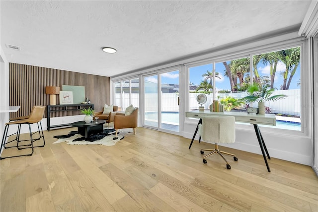 8001 13th Ave S, Saint Petersburg, FL 33707 - office area featuring wood finished floors and a textured ceiling