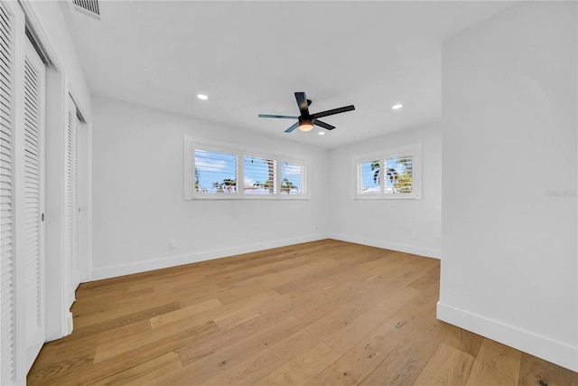 8001 13th Ave S, Saint Petersburg, FL 33707 - unfurnished bedroom featuring recessed lighting, light wood finished floors, a ceiling fan, and multiple closets
